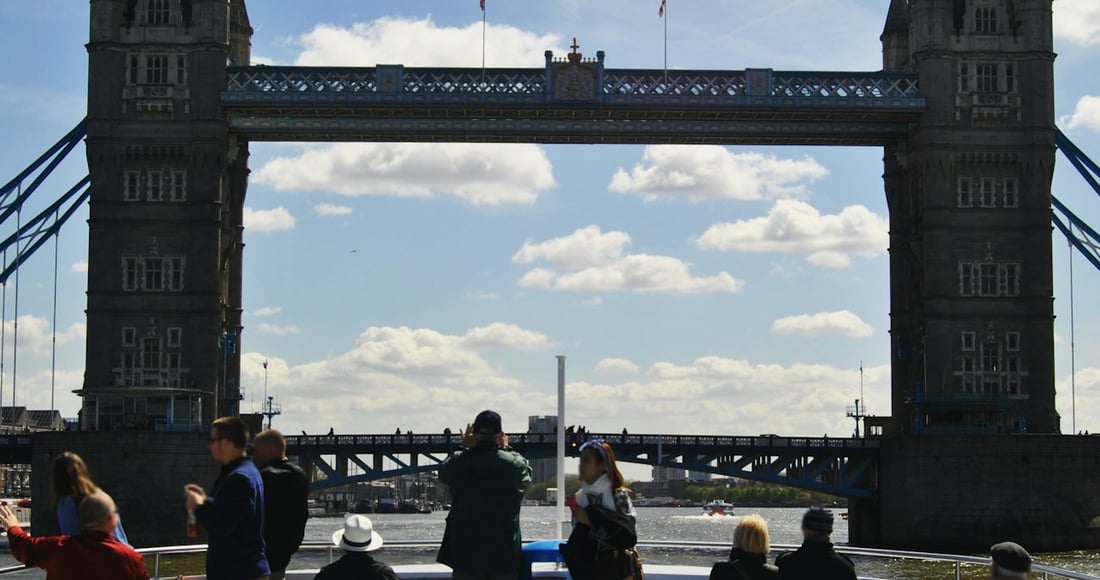 Thames river boat approaching Tower Pier with the Tower of London on the bank