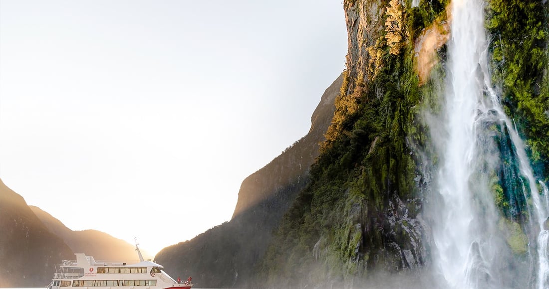 Helicopter landed on a snow-covered glacier high above Milford Sound