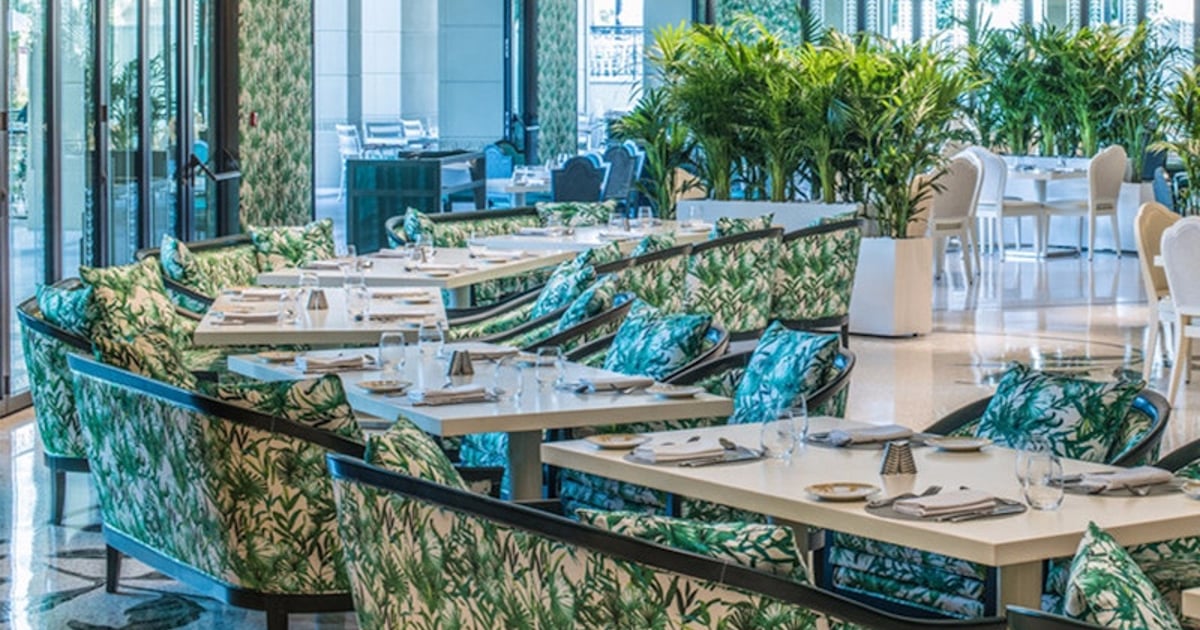 The interior of Nikos Taverna at The O2, the Greek-taverna setting for Mamma Mia! The Party, with palm-print banquettes and laid tables