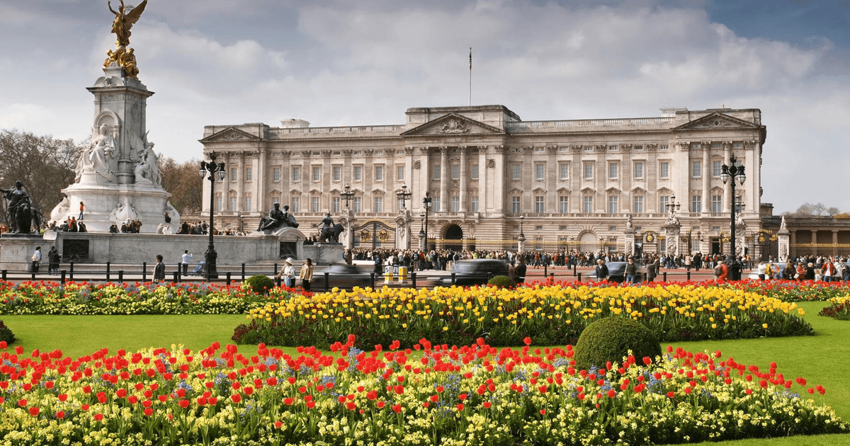Guards in red tunics and bearskin hats during Changing the Guard at Buckingham Palace