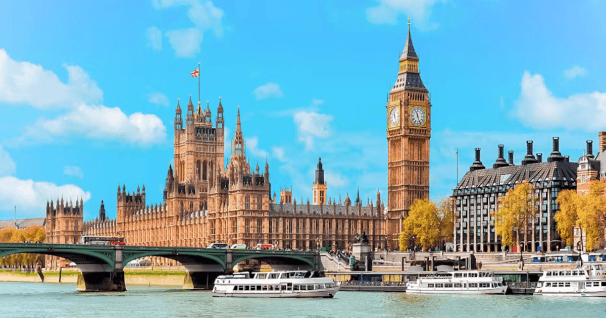 A boat passing central London landmarks on the River Thames on a summer day