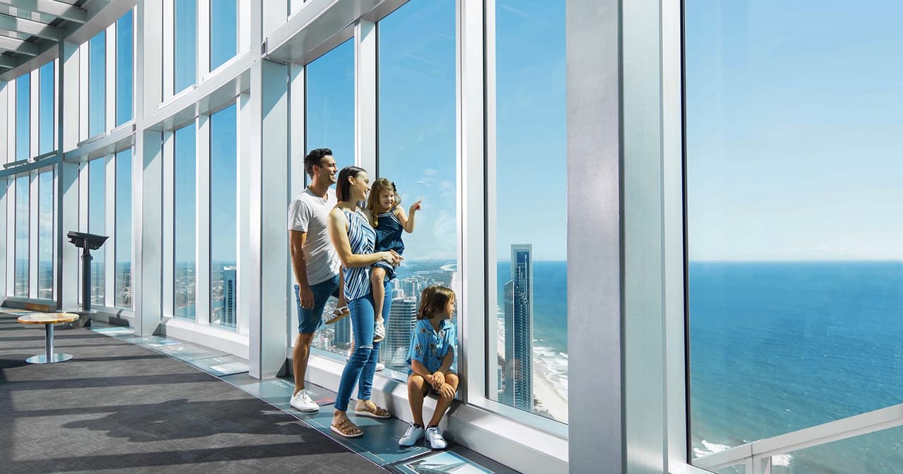 Family at the SkyPoint observation deck looking out over the Gold Coast coastline and ocean