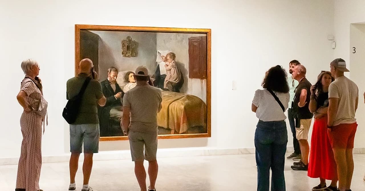 Visitors viewing a large painting in a bright white-walled Barcelona art museum