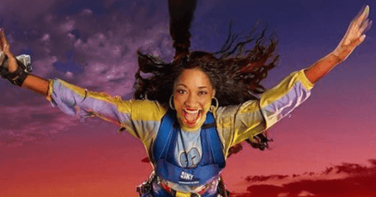 Thrill-seeker leaping in a harness high above the Las Vegas Strip skyline at sunset