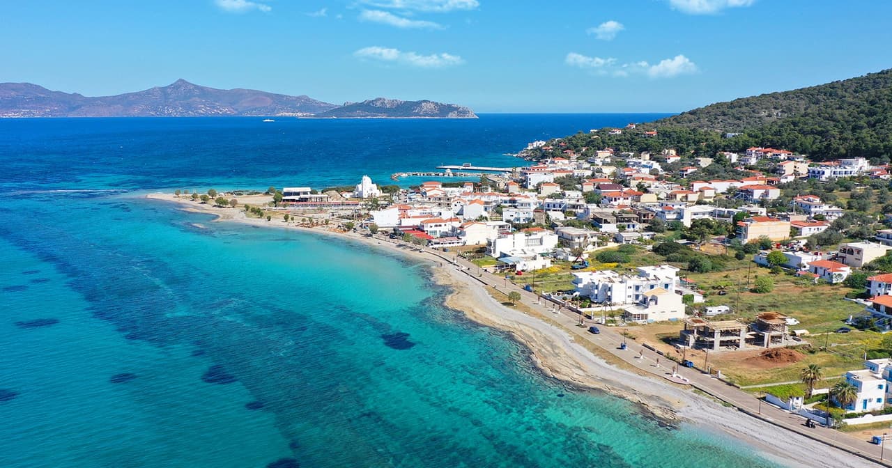 Aerial view of a Greek seaside town with turquoise water on a Saronic island near Athens