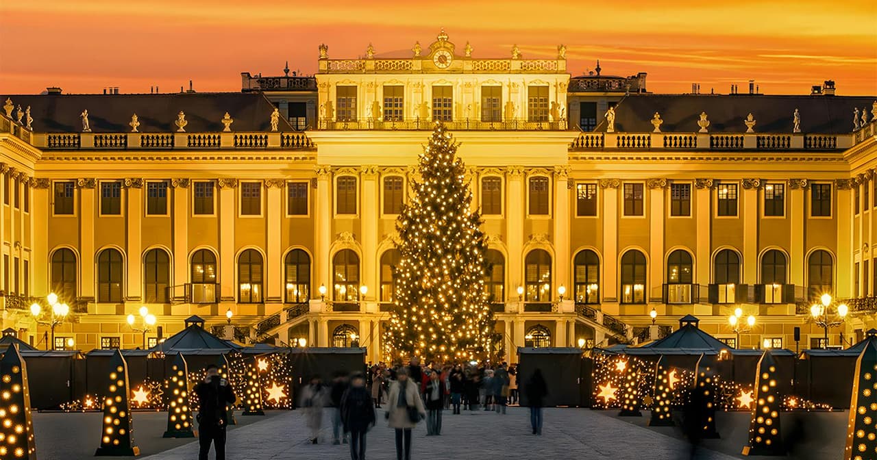 The Christmas market and illuminated Christmas tree in front of Schönbrunn Palace in Vienna