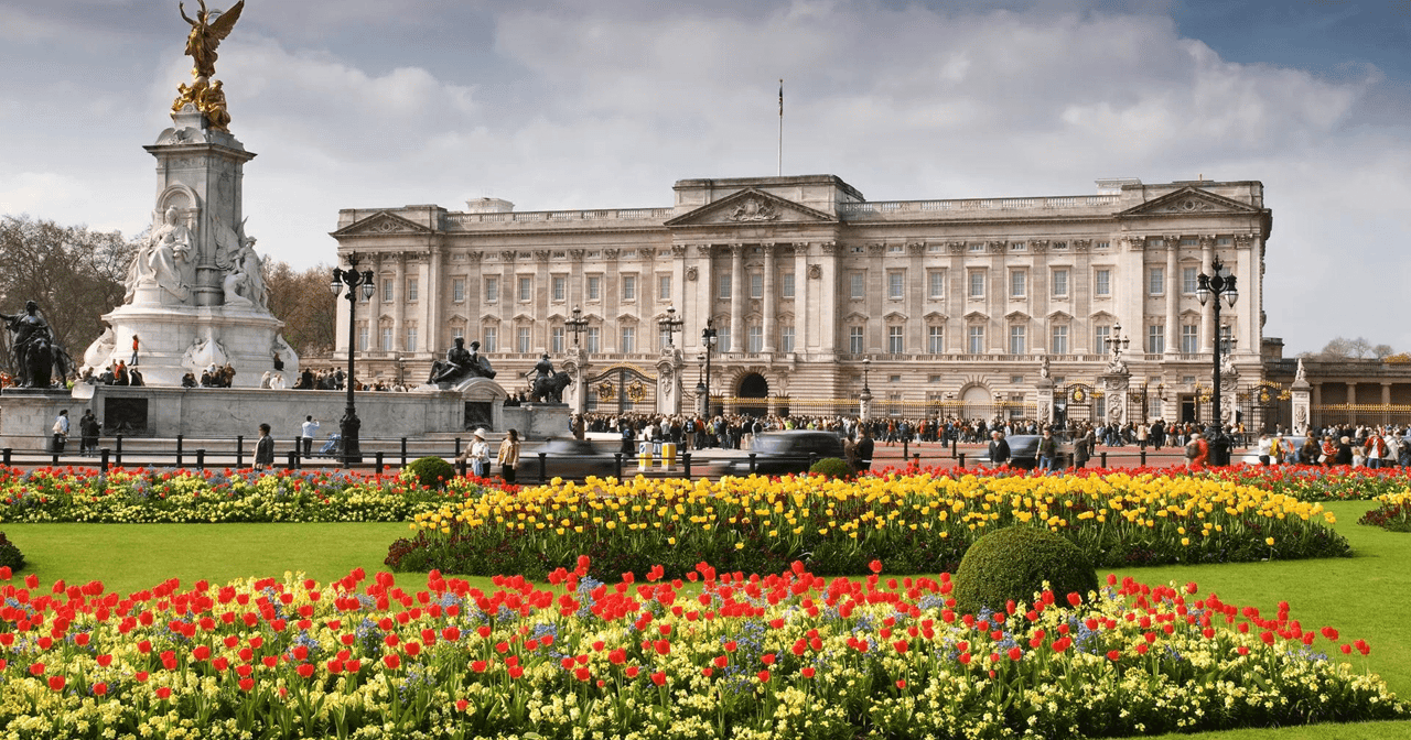 Guards in red tunics and bearskin hats during Changing the Guard at Buckingham Palace