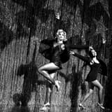 Two performers dancing in front of the silver fringe curtain in Chicago at the Ambassador Theatre on Broadway