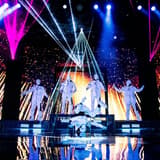 The masked Jabbawockeez dance crew performing under laser lights at MGM Grand in Las Vegas