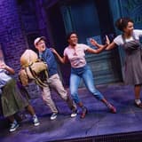 Seymour and the ensemble of Little Shop of Horrors on stage at the Westside Theatre
