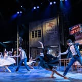 The company of Matthew Bourne's The Car Man dancing on the garage-diner set at Sadler's Wells. Photo by Johan Persson