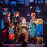 Paddington with the Brown family and Mr Gruber on stage in Paddington The Musical at the Savoy Theatre