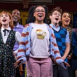The full company on stage under the Putnam County Spelling Bee banner at New World Stages in New York