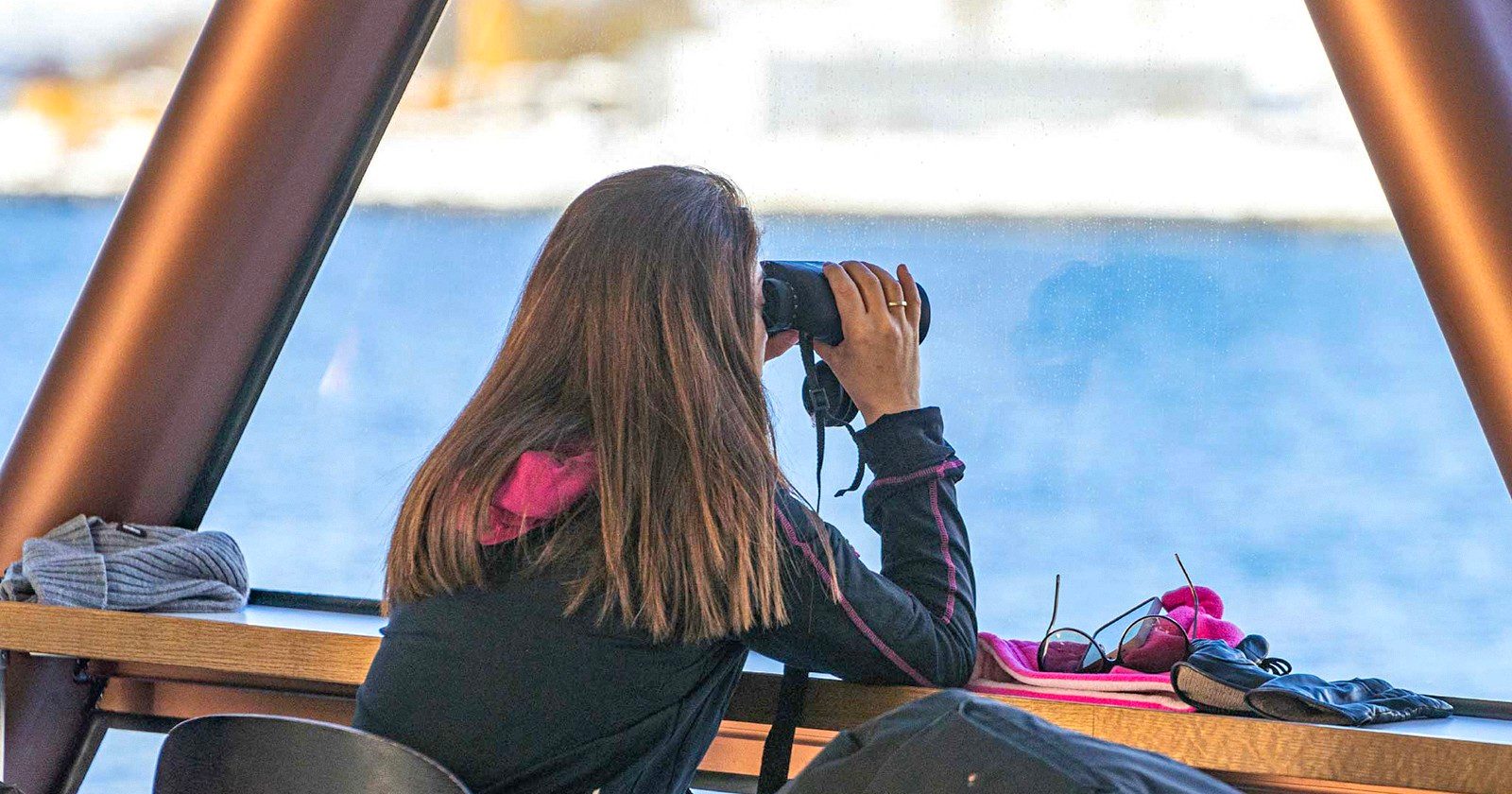 Traveller photographing the Arctic landscape on a Tromso fjord cruise