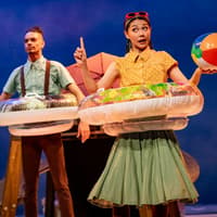 Stage performance of Stick Man in Westend with actors holding inflatable rings and a beach ball