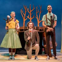 Performers on stage during Stick Man show, West End, with tree props in background