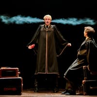 Two actors in wizard robes perform a scene from "Harry Potter and the Cursed Child" on stage