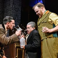 Actors in a comedic scene from "The Play That Goes Wrong" on stage