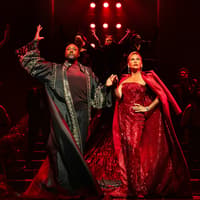 Stage performance of The Devil Wears Prada West End show with actors in elaborate costumes