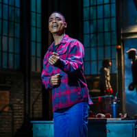 Performer singing on stage during Kinky Boots production