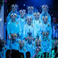 Performers in ornate masks during Mamma Mia! The Party show