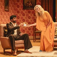 Stage scene from Abigail's Party, Westend, with two actors in a living room setting