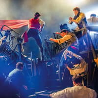 Actors perform a barricade scene from Les Misérables on stage