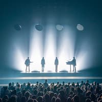 ABBA Voyage concert stage with band silhouettes and audience in London — Tickets to ABBA Voyage Concert with Express Coach Round-Trip Transfers from London