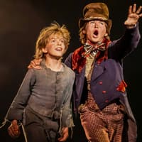 Two actors on stage in a scene from the musical "Oliver!