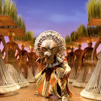 Lion King stage performance with actors in traditional costumes and lion mask — The Lion King