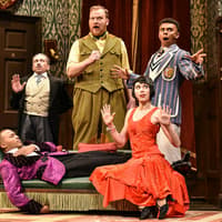 Actors performing a comedic scene in "The Play That Goes Wrong" on stage