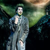Performer in Beetlejuice stage show, West End, with eerie backdrop