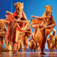 Performers in lion costumes on stage during The Lion King show in London