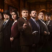 Cast of "The Mousetrap" in period costumes on stage