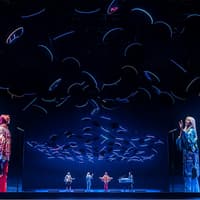 ABBA Voyage concert stage with holographic performers and dynamic lighting effects