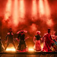 Performers on stage during Moulin Rouge! The Musical in West End, with dramatic lighting