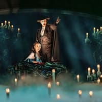 The Phantom leads Christine by candlelight to his lair, The Phantom of the Opera. Photo by Johan Persson