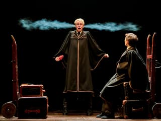 Two actors in wizard robes perform a scene from "Harry Potter and the Cursed Child" on stage