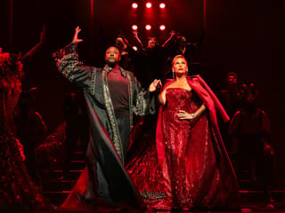 Stage performance of The Devil Wears Prada West End show with actors in elaborate costumes