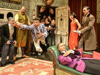 Actors performing a chaotic scene in "The Play That Goes Wrong" on stage