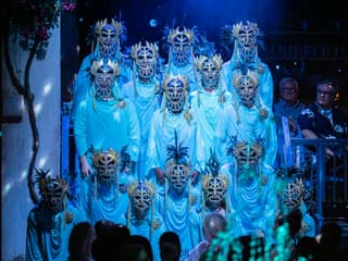 Performers in ornate masks during Mamma Mia! The Party show