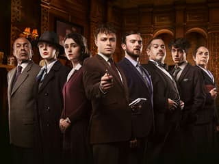Cast of "The Mousetrap" in period costumes on stage