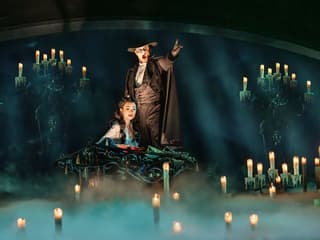 The Phantom leads Christine by candlelight to his lair, The Phantom of the Opera. Photo by Johan Persson