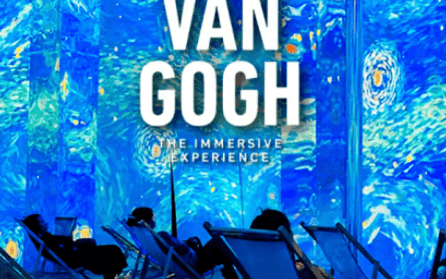 Van Gogh Starry Night projections on the walls with deckchairs at an immersive show in London
