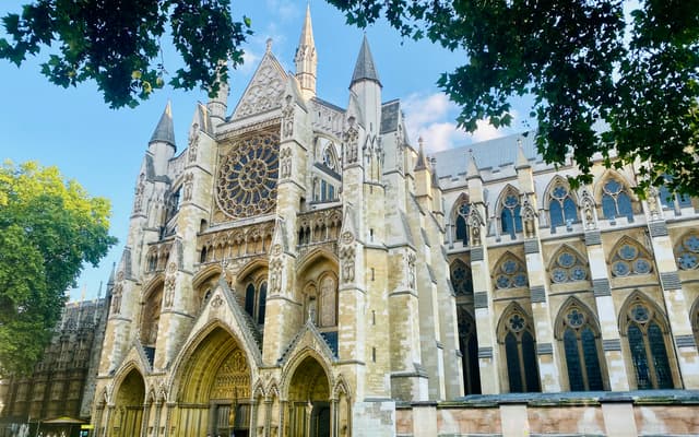 Westminster Abbey Gothic north facade and rose window framed by trees in London