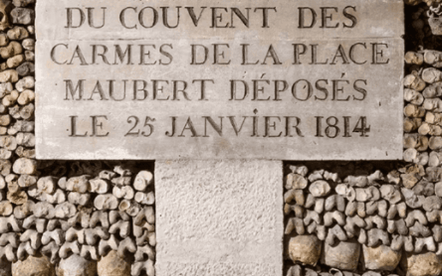 Engraved stone plaque deep inside the Paris Catacombs underground tunnels