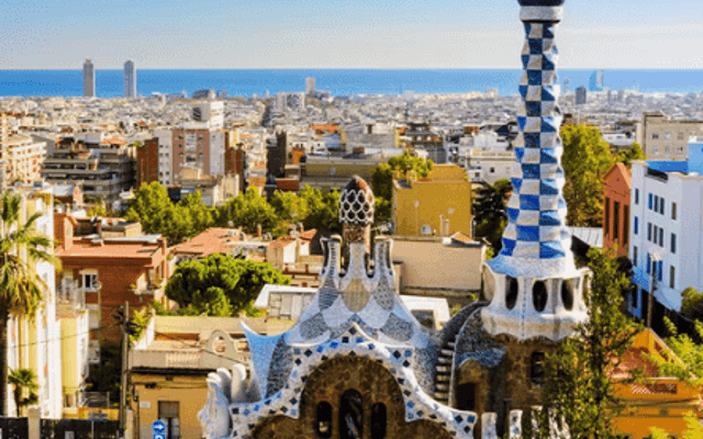Gaudi's Park Guell mosaic pavilions overlooking the Barcelona skyline and sea