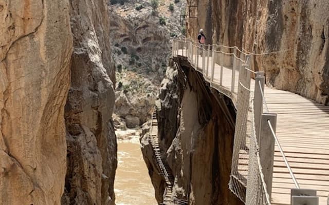 Wooden Caminito del Rey walkway clinging to the cliffs above a river gorge near Ardales