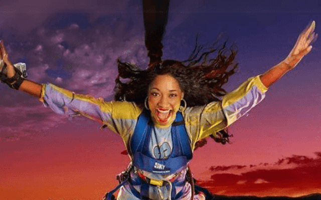 Thrill-seeker leaping in a harness high above the Las Vegas Strip skyline at sunset