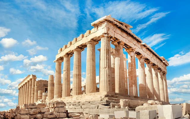 The Parthenon temple columns on the Acropolis of Athens against a bright blue sky